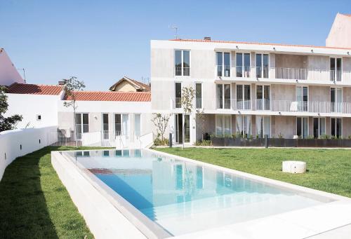 an image of a swimming pool in front of a building at FLH Mouraria Blue Design with Parking & Pool in Lisbon