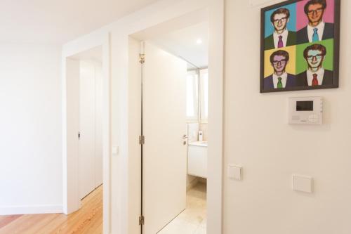 a hallway with a door with a painting on the wall at FLH Mouraria Blue Design with Parking & Pool in Lisbon