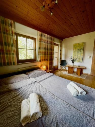 a large bed in a bedroom with two towels on it at Alpine cottage with exceptional view in Mayrhofen