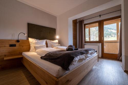 a bedroom with a large bed with a large window at Apart Leitner in Lermoos
