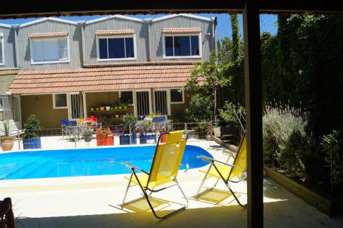 two yellow chairs sitting next to a swimming pool at El Jacal de San Pedro in San Pedro