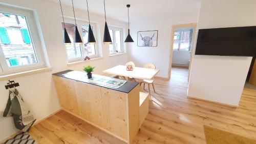 a living room with a desk and a flat screen tv at Yeti Lodge in Sedrun