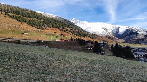 a view of a mountain with snow covered mountains at Yeti Lodge in Sedrun