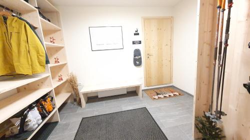a room with a walk in closet with a table at Yeti Lodge in Sedrun