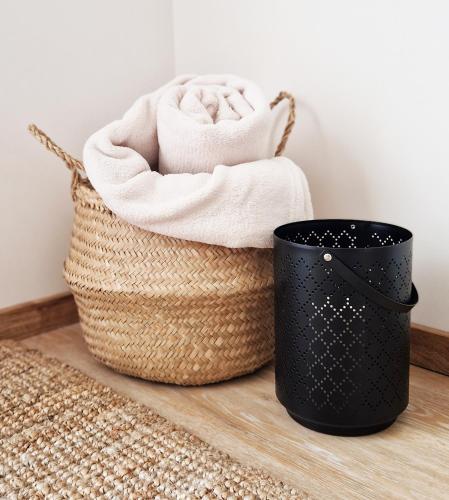 a basket with towels and a trash can at Apartmány Minoris in Liptovský Mikuláš