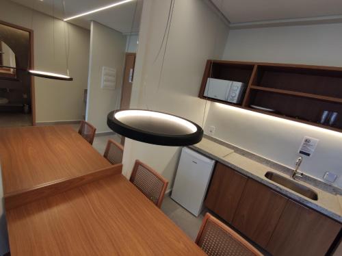 a conference room with a table and chairs and a sink at Ap particular 1001 ou 1201 no Salinas Premium Resort in Salinópolis