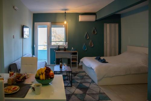 a bedroom with a bed and a table with fruit on it at The North Apartment in Kastoria