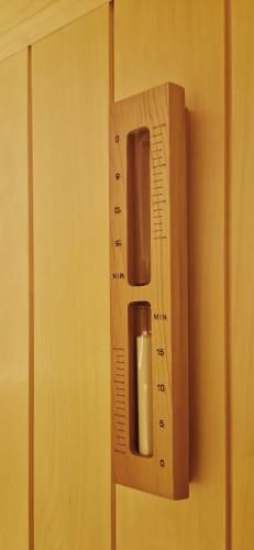 a wooden door handle on a wall with a thermometer at Apartmány Minoris in Liptovský Mikuláš