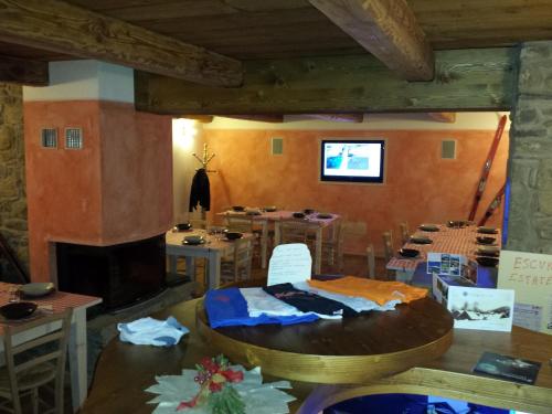 a room with a table and chairs and a fireplace at Il Borgo Dei Celti in Fiumalbo