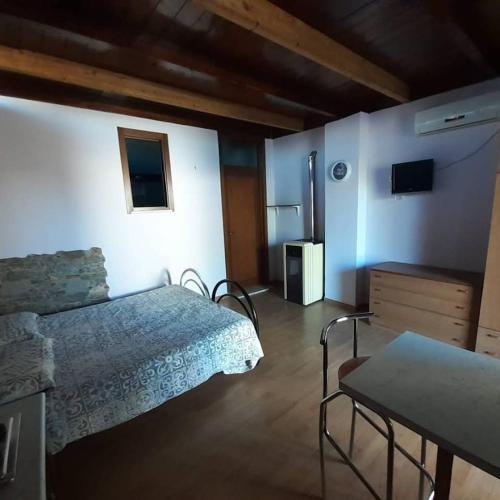1 dormitorio con 1 cama y 1 mesa en una habitación en B&B Bedafè, en Arnesano