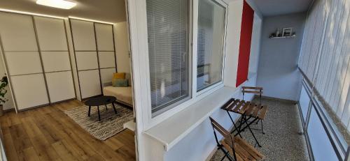 a balcony with two chairs and a window in a room at Apartment Terasa Kosice in Košice