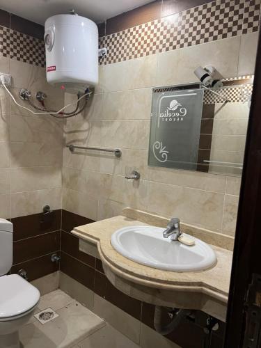 a bathroom with a sink and a toilet at Compound cecelia families only in Hurghada