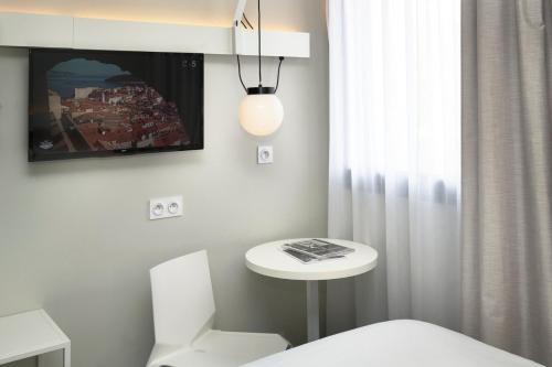 Кровать или кровати в номере Ibis Annecy - Cran-Gevrier