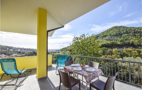a patio with a table and chairs on a balcony at Lovely Home In Chiavari With Wifi in Bacezza