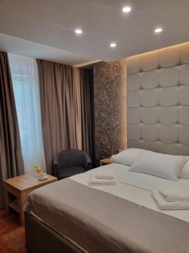 a hotel room with a large bed and a desk at Motel Bor in Vitez