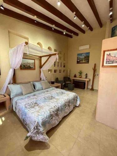 a bedroom with a large bed in a room at Erase una vez o la Catarina in Zihuatanejo