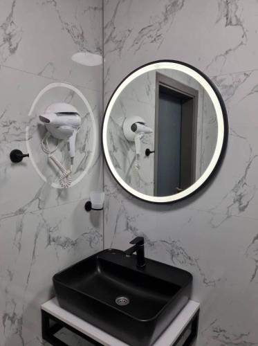 a bathroom with a black sink and a mirror at Motel Bor in Vitez