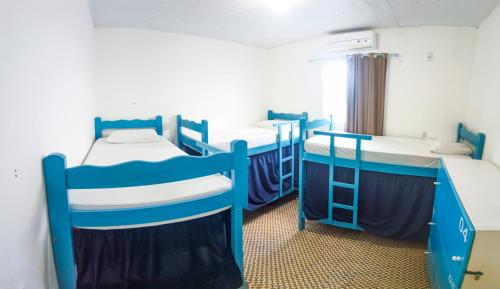 a room with three bunk beds in it at Hostel Dragão do Mar Fortaleza in Fortaleza