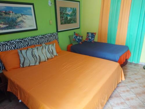 two beds sitting next to each other in a room at Terrakota Apartments in Willemstad