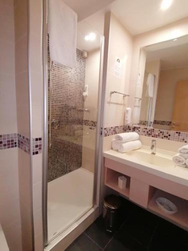 a bathroom with a shower and a sink at Kopaonik011 Konaci&WoodSide Apartments in Kopaonik
