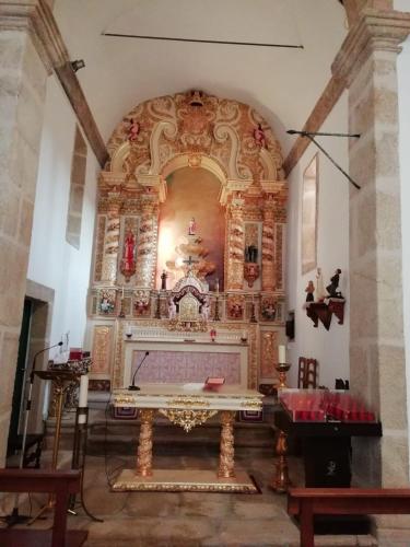 an altar in a church with a large at Casa da Fonte em Prada, Vinhais in Vinhais