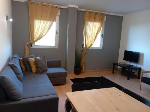 a living room with a couch and a table at Cardoso Pires 2 Bedrooms Apt. in Lisbon
