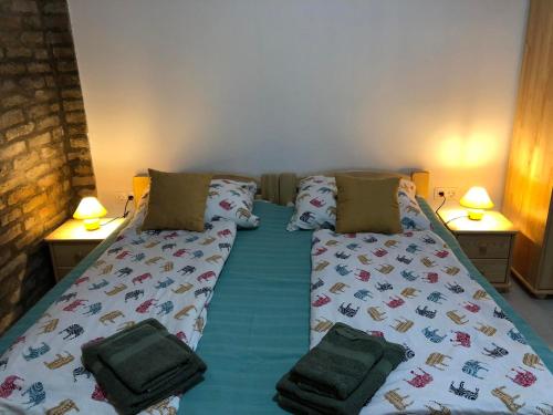 a bed in a room with two pillows on it at Fazekas Vendégház in Balatonkeresztúr