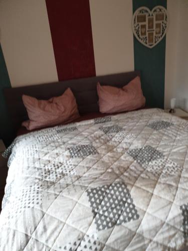 a bedroom with a bed with a quilt on it at Riposo in Emden