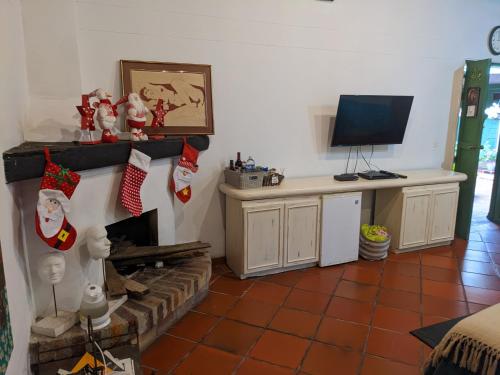 a living room with christmas ornaments on a fireplace at Casa Finca Paititi in San Antonio de Pereira