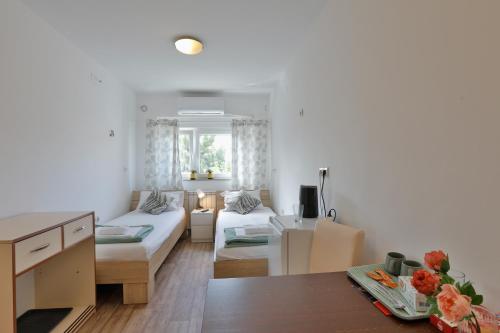a living room with a couch and a table at AVIATOR Apartments & Rooms Nikola Tesla Airport Belgrade in Surčin