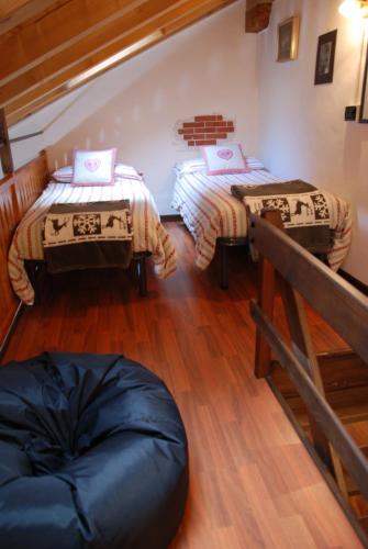 a room with two beds and a bean bag chair at Maisonette in Nus