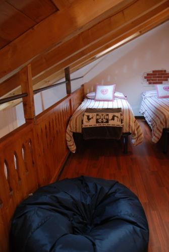 a room with two beds and a bean bag chair at Maisonette in Nus