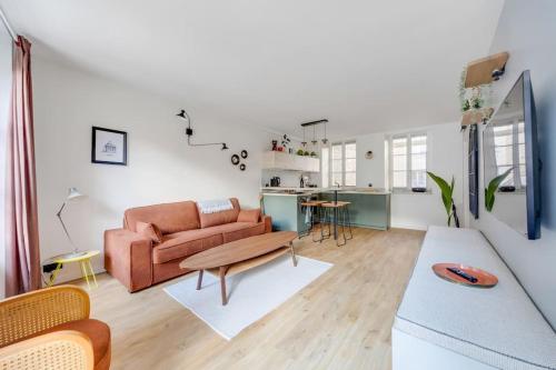 a living room with a couch and a table at A place to chill in Paris