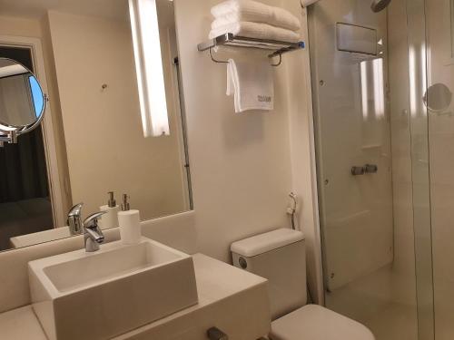 a bathroom with a sink and a toilet and a shower at Vila Olimpia Hotel in Sao Paulo