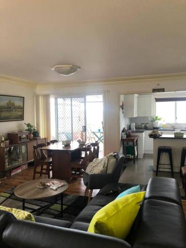 a living room with a couch and a table at Relaxing cottage overlooking Crookhaven River in Greenwell Point