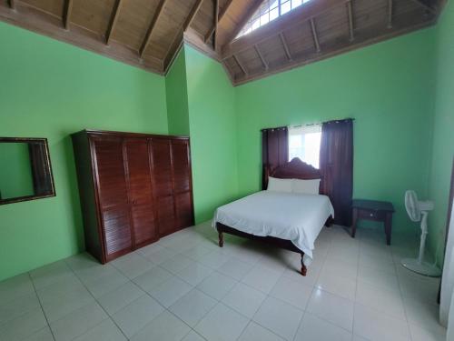 a bedroom with a bed and a window at Wizzy Apartment in Ocho Rios