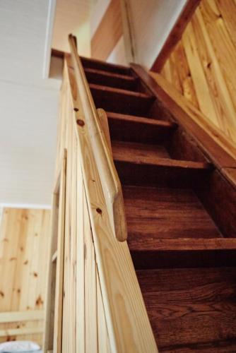 a wooden staircase in a room with wooden floors at SOVIA WELLNESS CHATA s jacuzzi kaďou a saunou, Čingov in Smižany