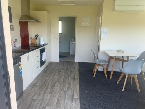 a kitchen and dining room with a table and chairs at Guest Suite in Peaceful Location Roxburgh in Dumbarton