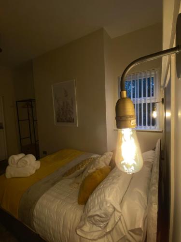 a bedroom with a bed with a light on it at Cosy Loft Apartment in Ballycastle