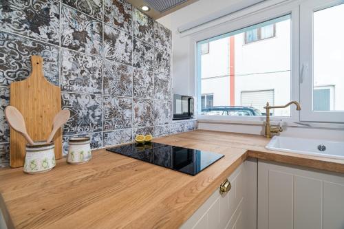 a kitchen with a sink and a counter top at Casa Estábulo- Cozy Rustic Farmhouse (HORSE LOFT) in Estômbar