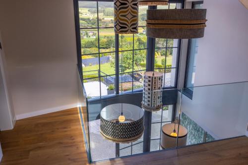 a room with a large window and a table and chairs at De la Osa Hotel in Abres