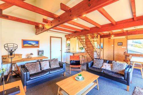 a living room with couches and a table at Alpine Rest - Lake Tekapo in Lake Tekapo