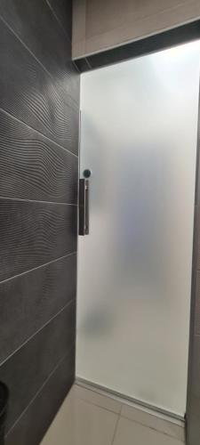a white door in a bathroom with a wall at Apartment SAND - Entry with PIN 0 - 24h, Luxury massage chair,Infrared sauna,FREE CANCELLATION 24 hours before Check In, Premium pillows and mattress in Slavonski Brod