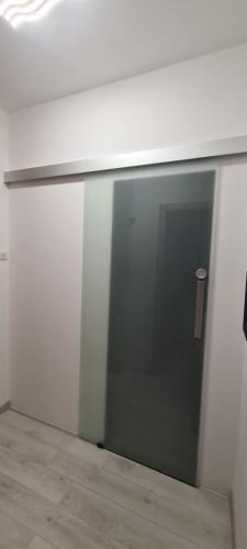a sliding glass door on a white wall with a counter at Apartment SAND - Entry with PIN 0 - 24h, Luxury massage chair,Infrared sauna,FREE CANCELLATION 24 hours before Check In, Premium pillows and mattress in Slavonski Brod