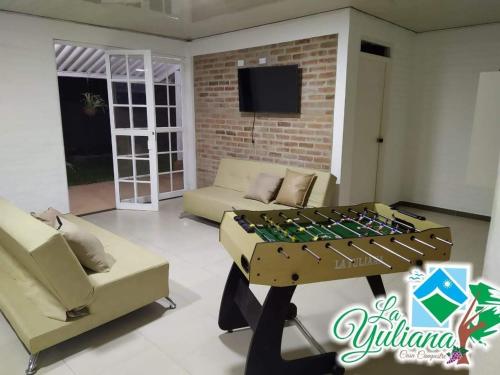 a living room with a foosball table and couch at Casa Campestre La Yuliana in Santa Helena