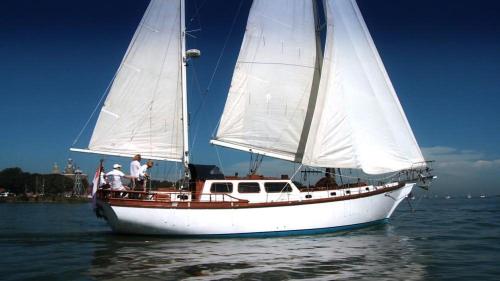 a white sail boat floating on the water at Classic sailing ship in center of Enkhuizen! in Enkhuizen