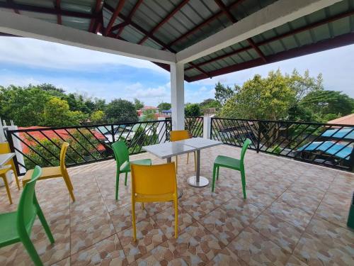 a patio with a table and chairs on a balcony at Alona's Traditional Filipino Home near 100 Islands Wharf in Alaminos