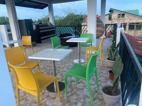 a group of chairs and tables on a patio at Alona's Traditional Filipino Home near 100 Islands Wharf in Alaminos