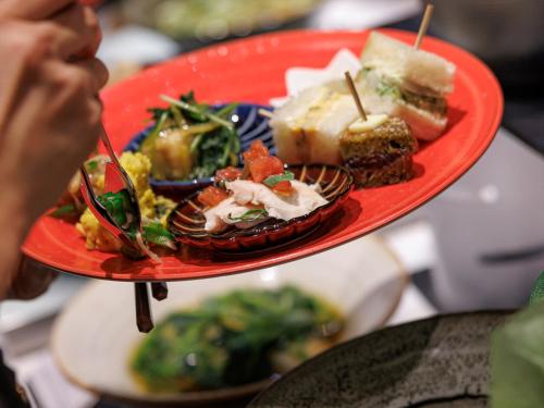 a red plate of food on a red tray at THE BLOSSOM KYOTO in Kyoto