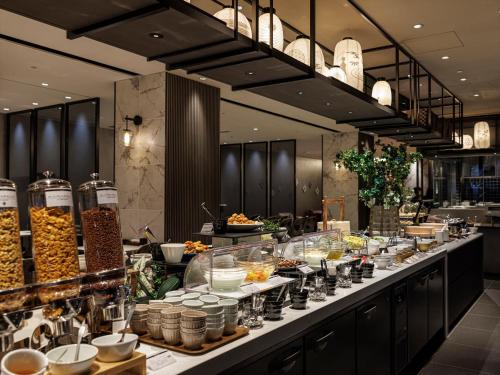 a buffet line with food on display in a restaurant at THE BLOSSOM KYOTO in Kyoto